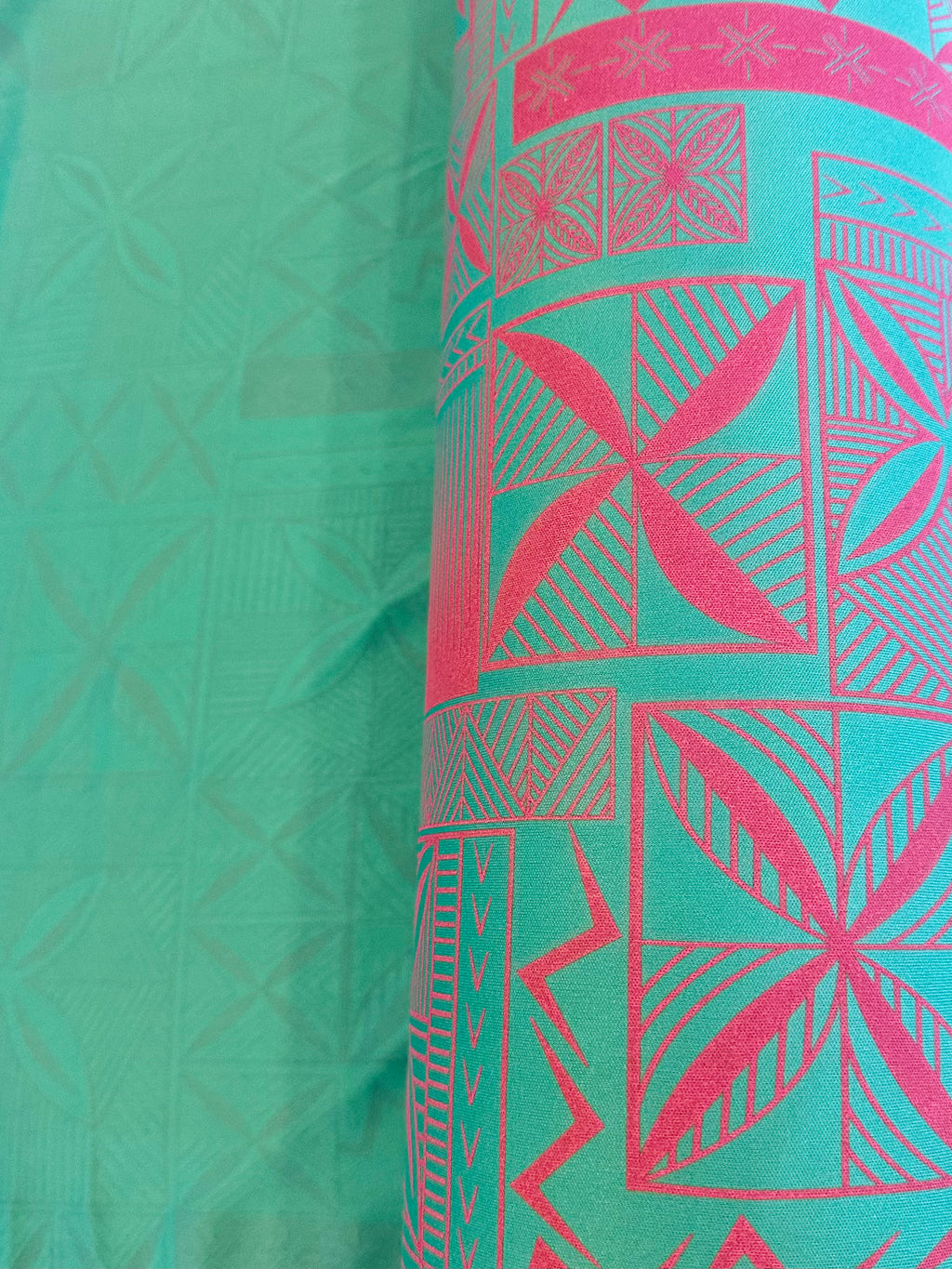 Green fabric with pink geometric patterns