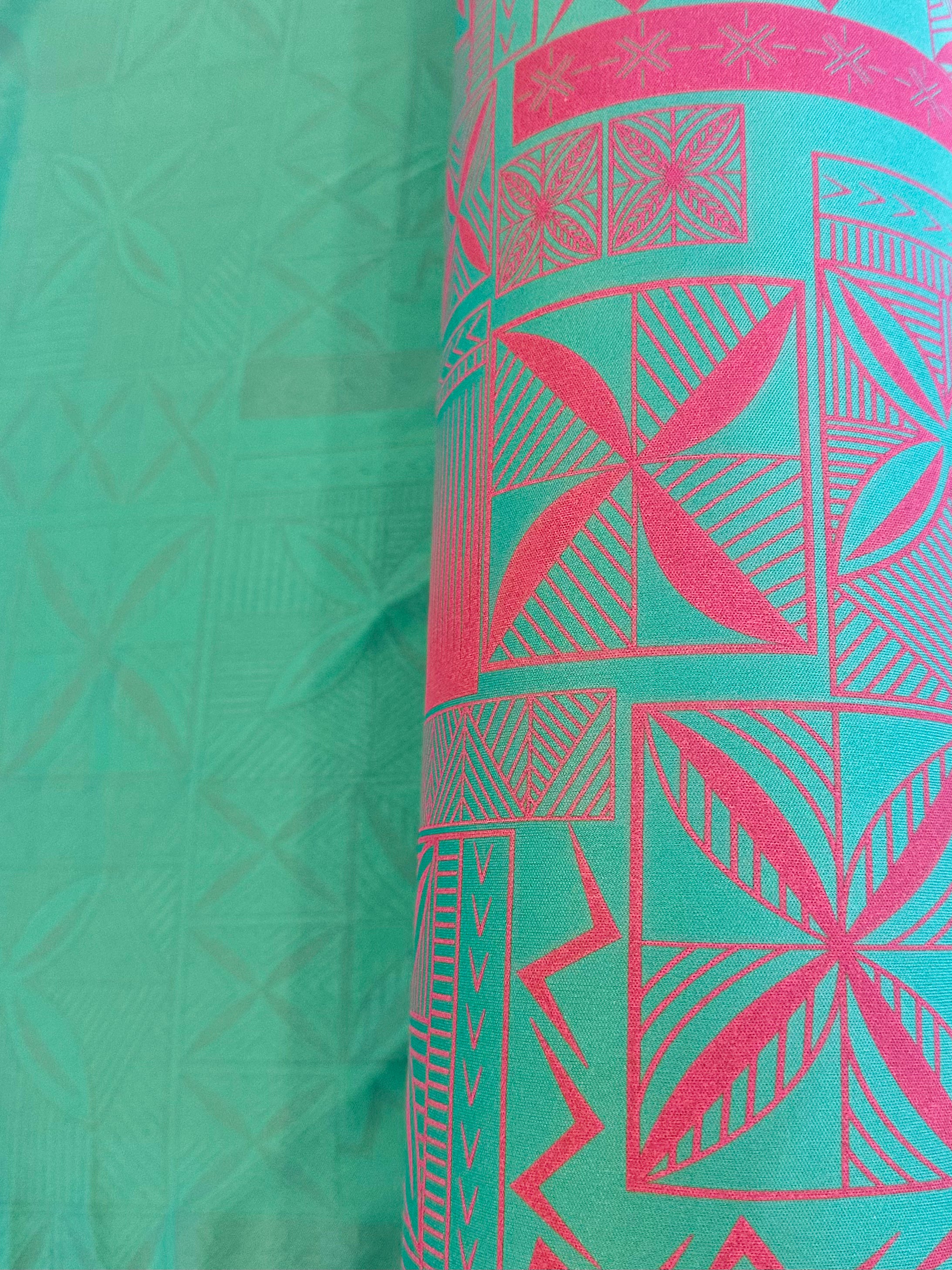 Green fabric with pink geometric patterns